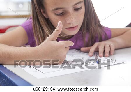 Picture - Girl doing the exercise of math. Fotosearch