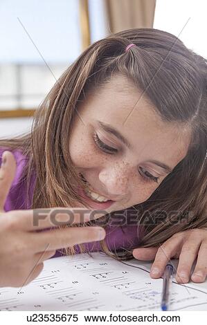 Stock Photography - Girl doing the exercise of math. Fotosearch