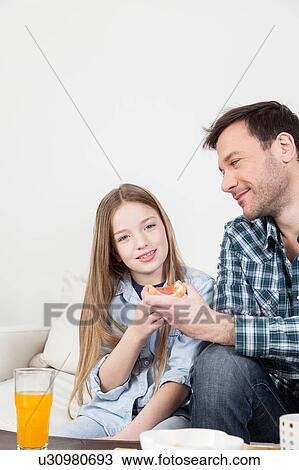 Girl having a breakfast with her father. View Large Photo Image Stock Image - Girl having a breakfast with her father.. Fotosearch