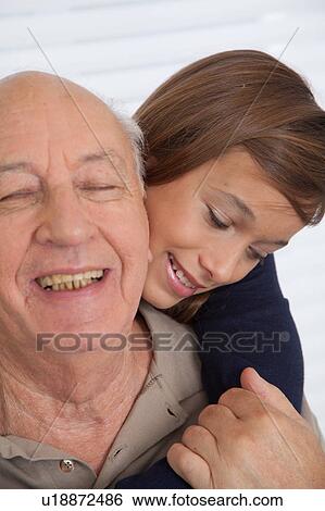 Stock Photograph - girl having fun with her grandfather. Fotosearch