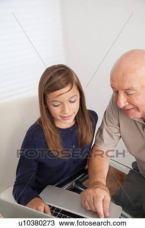 Girl helping to her grandfather with the computer View Large Photo Image Stock Image - Girl helping to her grandfather with the computer. Fotosearch