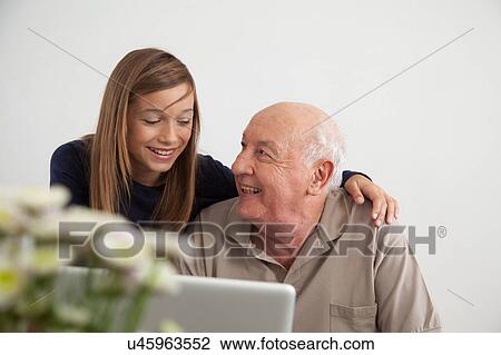 Girl helping to her grandfather with the computer View Large Photo Image Stock Image - Girl helping to her grandfather with the computer. Fotosearch