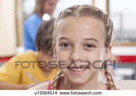 Picture - Girl looking at camera and smiling. Fotosearch