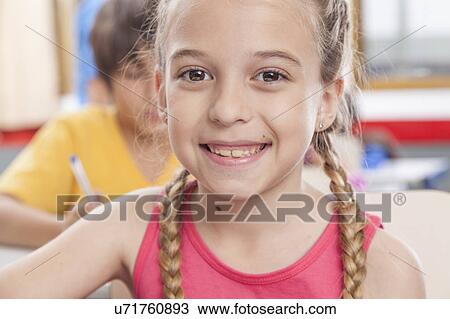 Girl looking at camera and smiling View Large Photo Image Stock Image - Girl looking at camera and smiling. Fotosearch