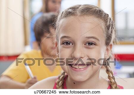 Girl looking at camera and smiling View Large Photo Image Stock Photography - Girl looking at camera and smiling. Fotosearch