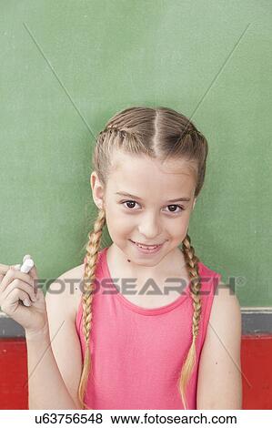 Stock Photo - Girl looking at camera with chalk. Fotosearch