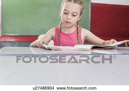 Picture - Girl reading at school. Fotosearch