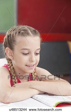 Girl reading at school View Large Photo Image Picture - Girl reading at school. Fotosearch