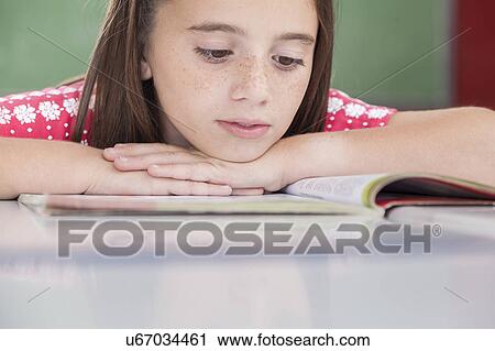 Girl reading at school View Large Photo Image Stock Image - Girl reading at school. Fotosearch