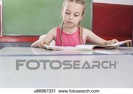 Girl reading at school View Large Photo Image Stock Image - Girl reading at school. Fotosearch