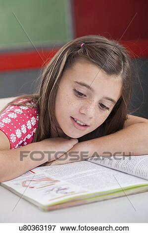 Girl reading at school View Large Photo Image Stock Photo - Girl reading at school. Fotosearch