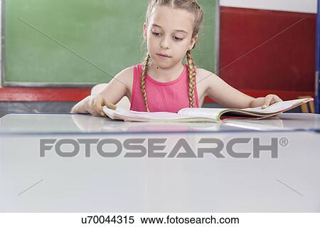 Girl reading at school View Large Photo Image Stock Photography - Girl reading at school. Fotosearch