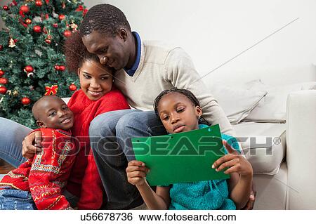 Stock Photograph - Girl reading the letter that wrote to Santa. Fotosearch