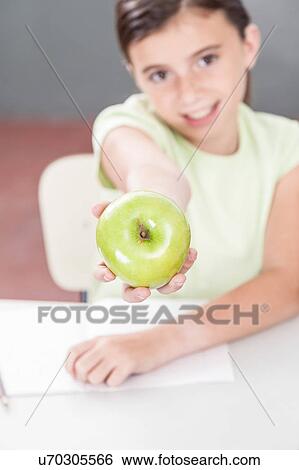 Girl sharing a apple View Large Photo Image Stock Photograph - Girl sharing a apple. Fotosearch