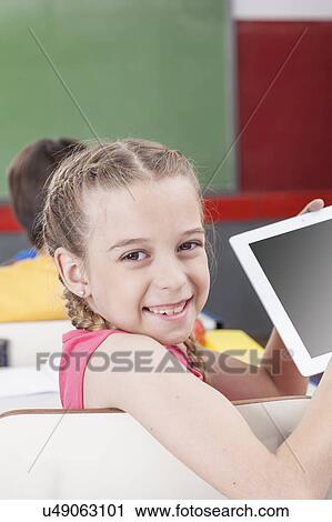 Girl showing the tablet View Large Photo Image Stock Image - Girl showing the tablet. Fotosearch