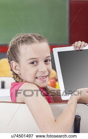 Girl showing the tablet View Large Photo Image Stock Photo - Girl showing the tablet. Fotosearch