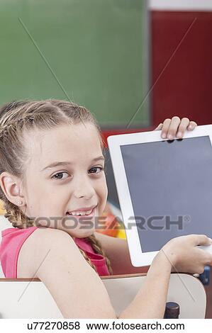 Girl showing the tablet View Large Photo Image Stock Photo - Girl showing the tablet. Fotosearch