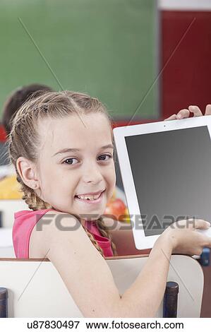 Girl showing the tablet View Large Photo Image Stock Photo - Girl showing the tablet. Fotosearch