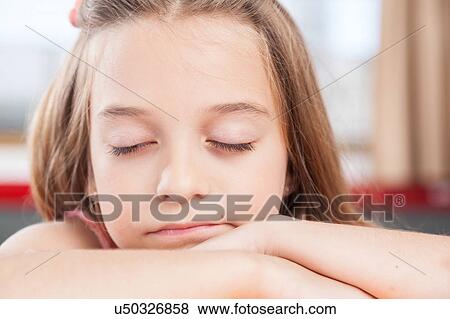 Stock Photo - girl sleeping in class. Fotosearch