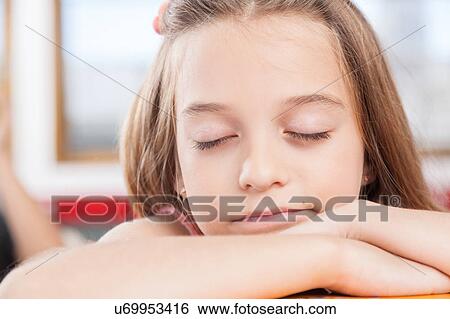 Stock Photograph - girl sleeping in class. Fotosearch