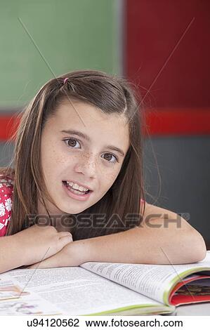 Stock Image - Girl smiling and looking at camera. Fotosearch