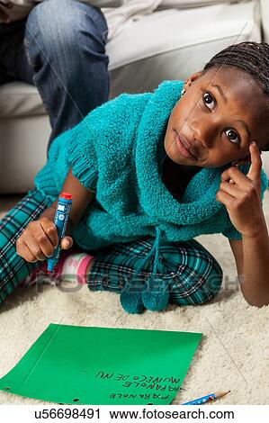 Girl thinking to put in the letter to santa claus View Large Photo Image Stock Image - Girl thinking to put in the letter to santa claus. Fotosearch