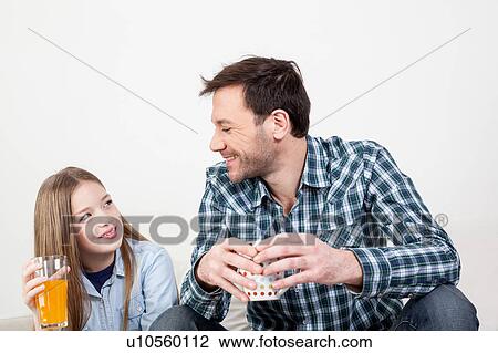 Girl with his father drinking juice View Large Photo Image Stock Image - Girl with his father drinking juice. Fotosearch