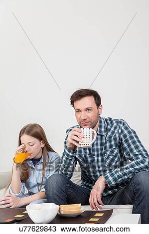 Girl with his father drinking juice View Large Photo Image Stock Image - Girl with his father drinking juice. Fotosearch