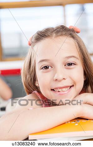 Stock Image - Girl with text books. Fotosearch