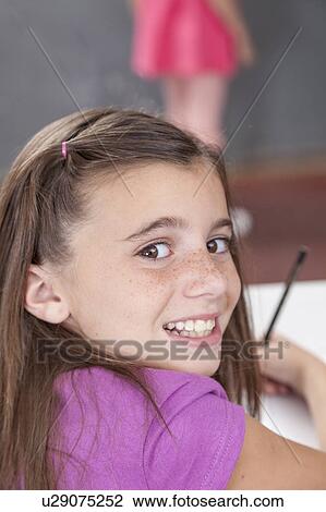 Girl writing in her notebook View Large Photo Image Stock Image - Girl writing in her notebook. Fotosearch