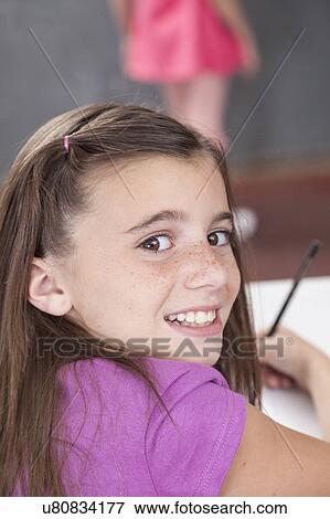 Stock Photo - Girl writing in her notebook. Fotosearch