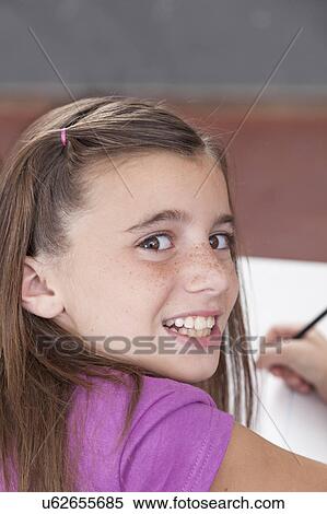 Girl writing in her notebook View Large Photo Image Stock Photography - Girl writing in her notebook. Fotosearch