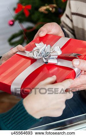 Giving a gift View Large Photo Image Stock Image - Giving a gift. Fotosearch