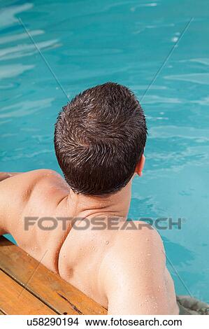 Guy back in the edge of the pool View Large Photo Image Picture - Guy back in the edge of the pool. Fotosearch