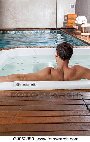 Stock Image - Guy back inside a jacuzzi. Fotosearch