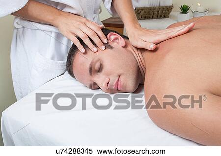 Stock Photography - Guy enjoying a massage. Fotosearch