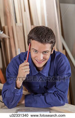 Stock Image - Guy holding a pencil. Fotosearch