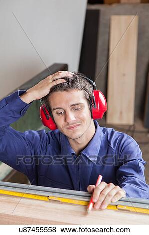 Stock Photo - Guy holding his head. Fotosearch