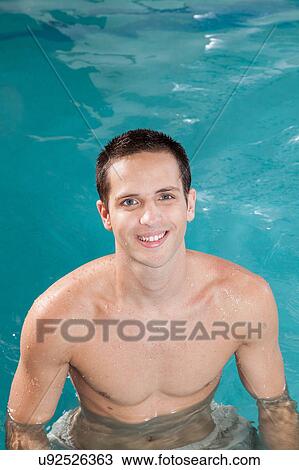 Stock Image - Guy inside the pool. Fotosearch
