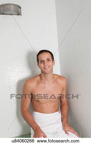Stock Photograph - Guy inside the sauna. Fotosearch