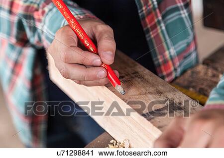 Guy marking wood with a pencil View Large Photo Image Stock Image - Guy marking wood with a pencil. Fotosearch