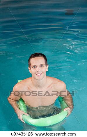 Stock Photograph - Guy playing inside the pool. Fotosearch