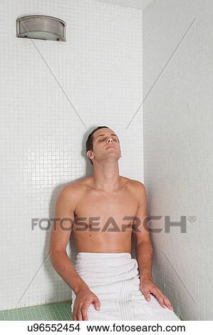 Picture - Guy relaxed inside the sauna. Fotosearch