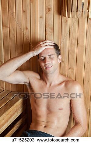 Stock Image - Guy relaxed inside the sauna. Fotosearch