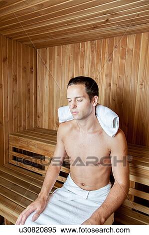 Stock Photography - Guy relaxed inside the sauna. Fotosearch
