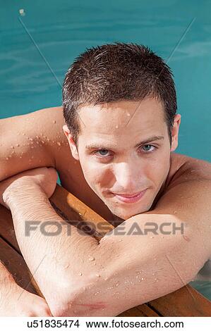 Guy rest in the edge of the pool View Large Photo Image Picture - Guy rest in the edge of the pool. Fotosearch