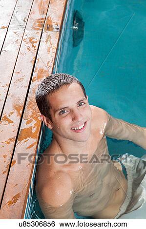 Stock Photograph - Guy resting in the pool. Fotosearch