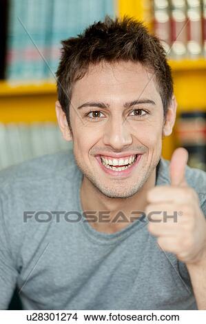 Picture - Guy with his thumb up. Fotosearch