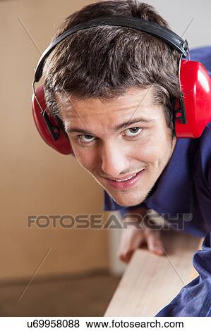 Stock Photo - Guy with protectors hearing. Fotosearch