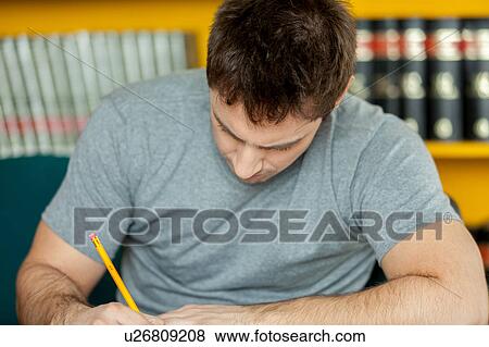 Stock Photo - Guy writing. Fotosearch